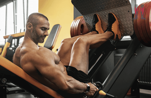 A strong man doing legpress, heavy.